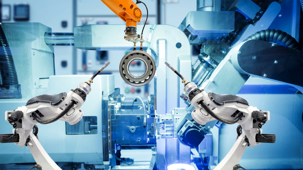 Two manufacturing robots fixing a bearing. (Image Source | Unsplash)